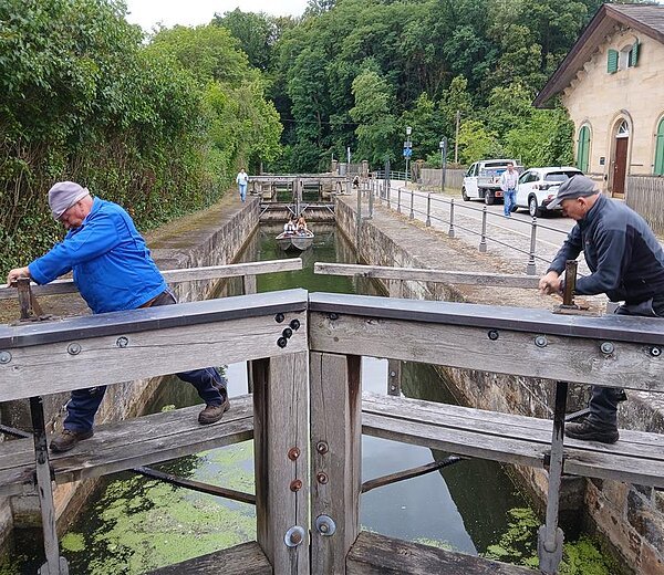 Die Bamberger Flussmeister des Wasserwirtschaftsamtes Kronach öffnen die Tore der Schleuse 100 am alten Kanal. Foto: Richter/WWA Kronach